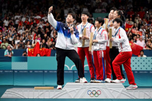 North Korea’s Ri Jong Sik (2nd L), and North Korea’s Kim Kum Yong (C) join in the selfie taken by South Korea’s Lim Jonghoon (L) in the Paris Olympics. Photograph: Jung Yeon-Je/AFP/Getty Images