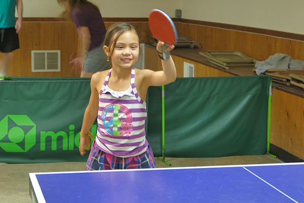 Young girl with table tennis paddle